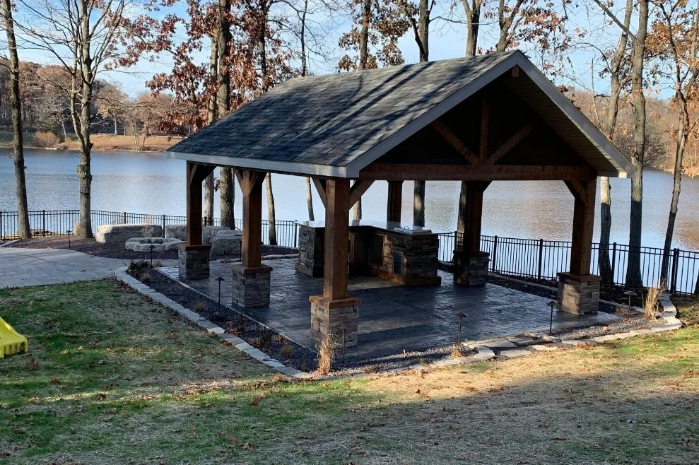 Covered patio structure near a lake