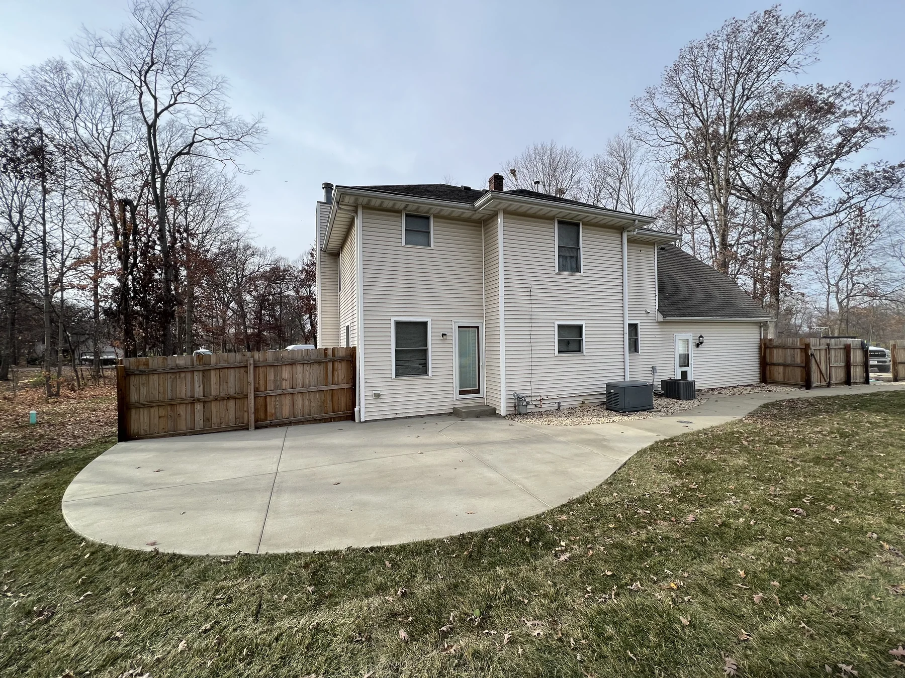 Curved concrete patio beside a home