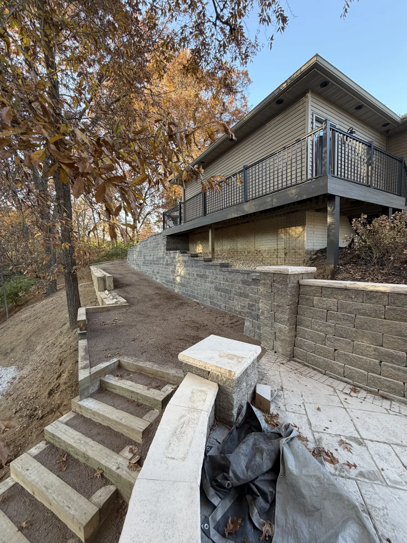 Stone steps and retaining wall beside a deck