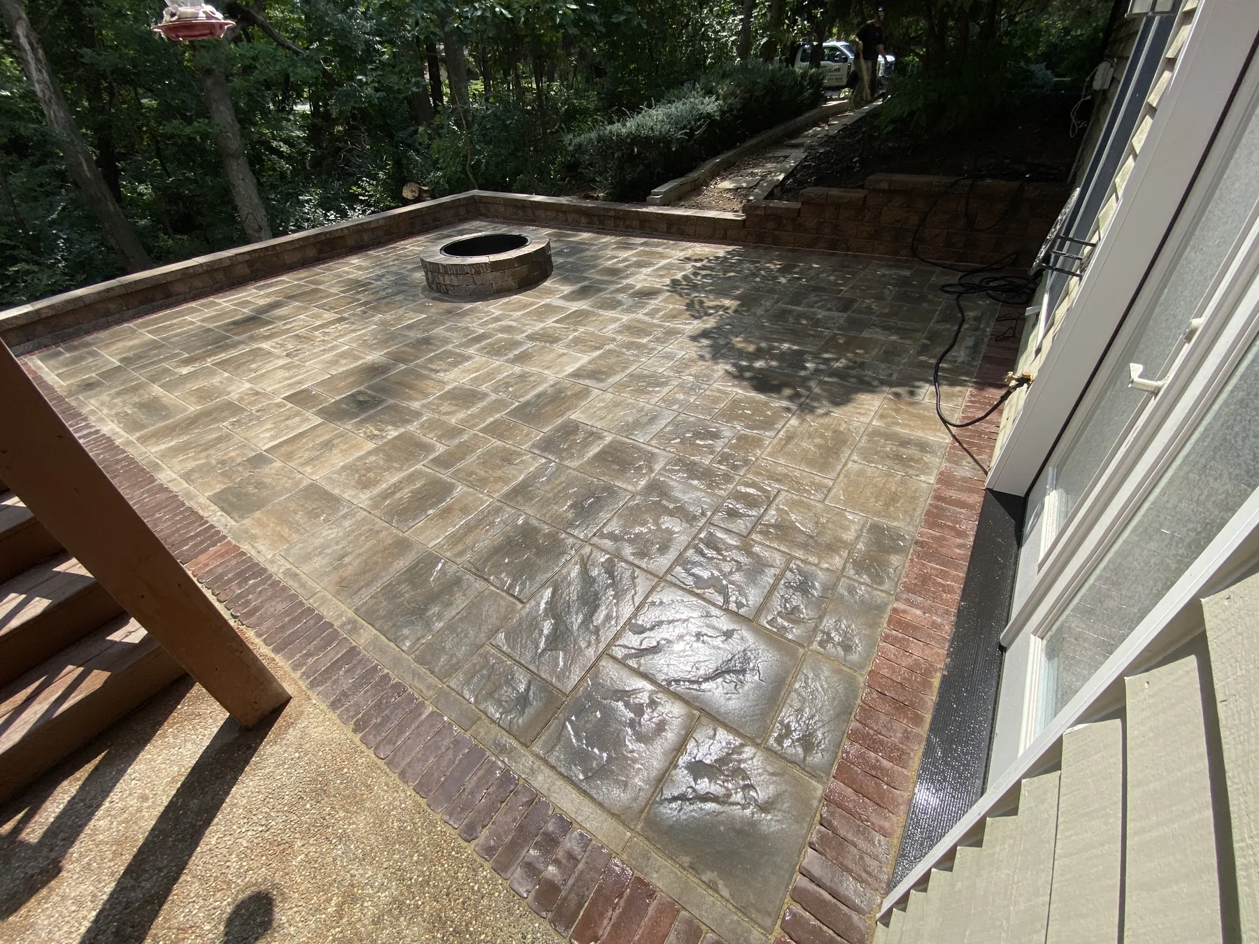 Stamped patio with fire pit by Zehr Property Maintenance