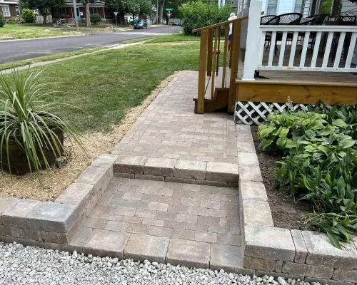 Paver walkway with border near a porch
