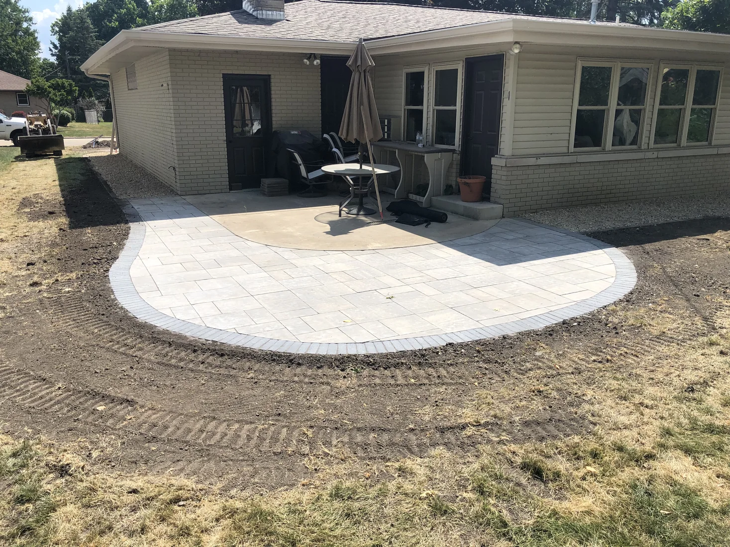 Rounded concrete patio behind a home