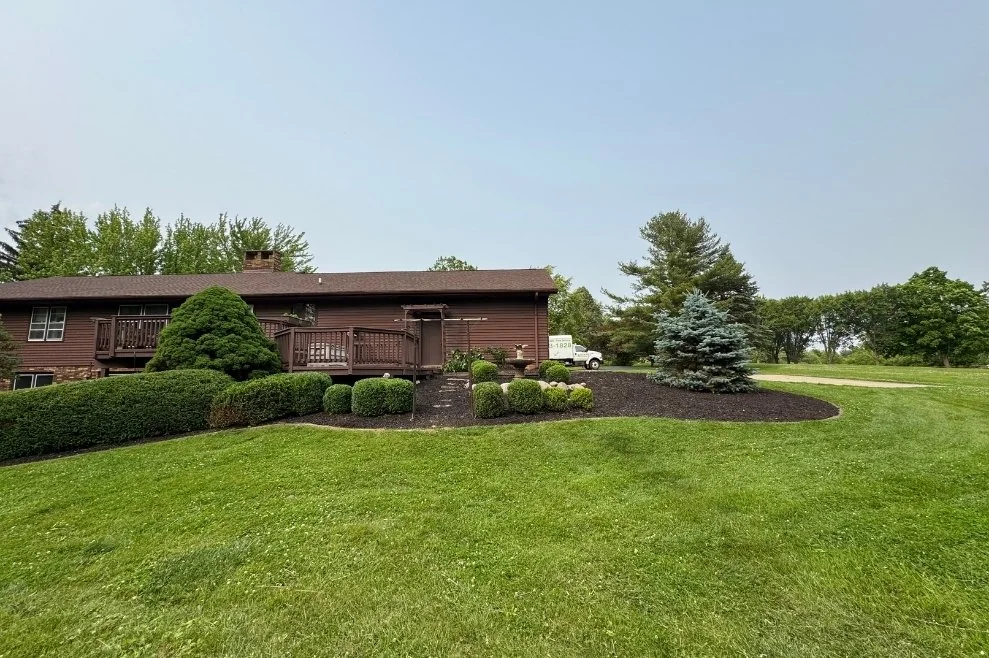 Well-maintained lawn and landscape beds