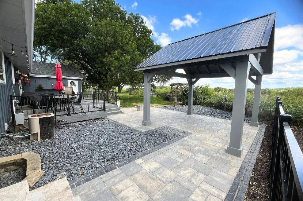 Covered outdoor living area with pavers and gravel