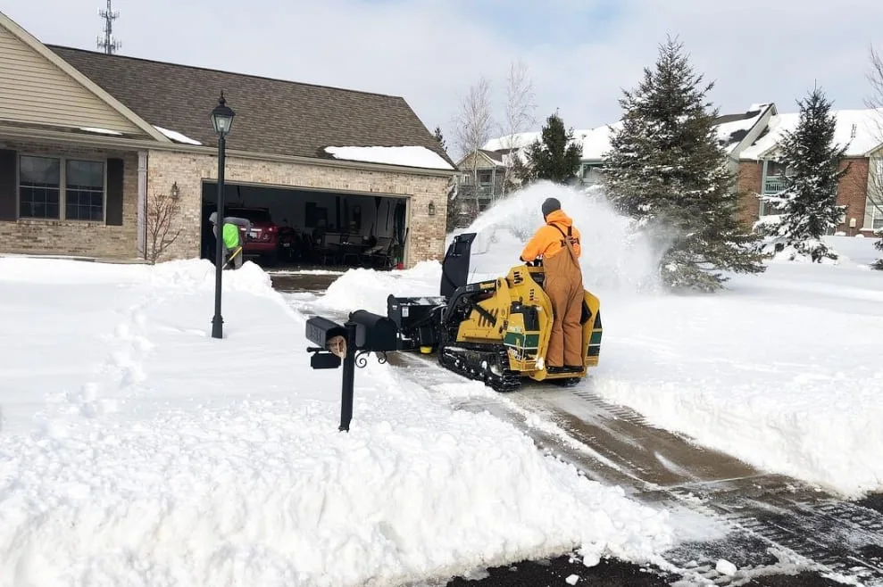 Snow removal equipment clearing a driveway